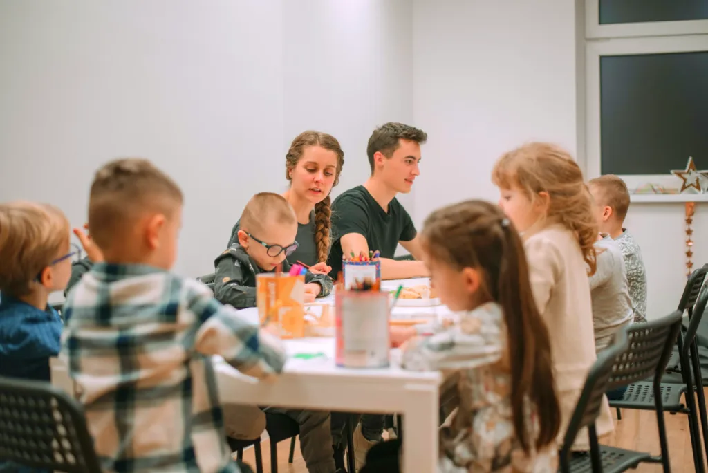 Children drawing with leaders at a kids club meeting at Christian Centre Martin
