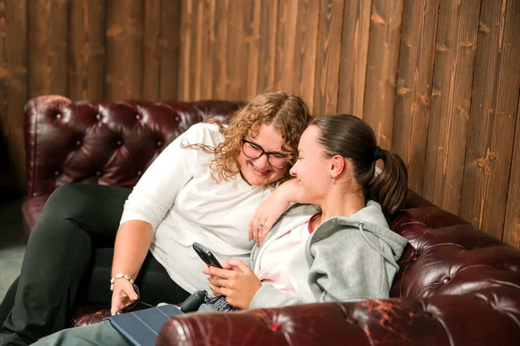 Two girls laughing on a couch at Friday youth at Christian Centre Martin
